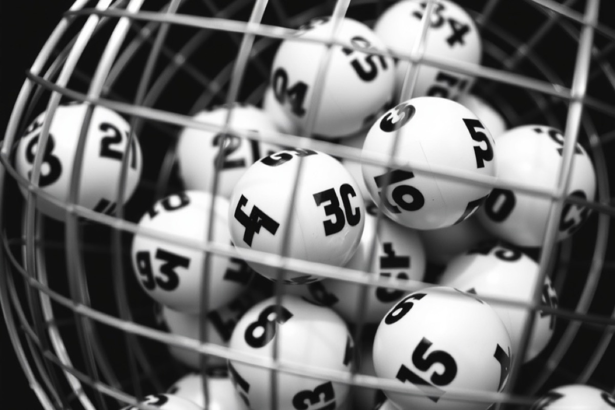 Bingo balls tumbling inside a wire cage drum